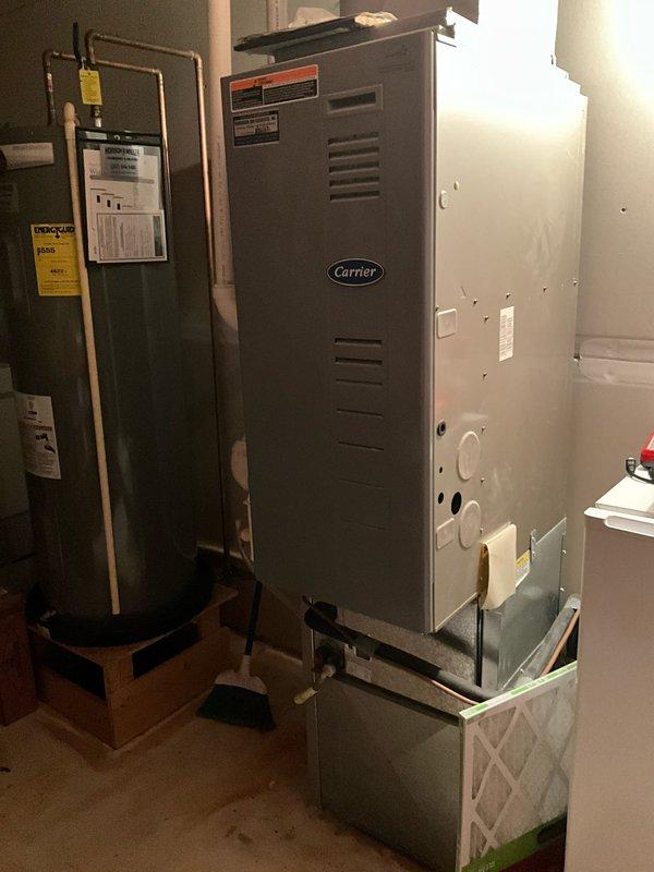 Completed estimate for replacement of existing Carrier furnace and air conditioning system located in upstairs closet. Assessed current HVAC equipment configuration, including furnace positioned in utility closet at top of stairs alongside water heater, documented existing installation conditions, and provided recommendations for new system installation to replace aging heating and cooling equipment.