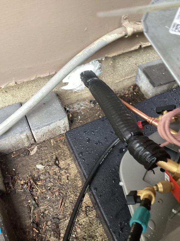 Completed full HVAC system installation including new furnace, air conditioning unit, thermostat, AprilAire 700M humidifier, Patriot 80 furnace, and F100 filter cabinet with PVC adaptation for condensate drainage. Brazed refrigerant lines and installed exterior condensate drain piping with proper mounting and secure connections to building exterior. All work performed in coordination with licensed electrician and proper permits obtained per code requirements.