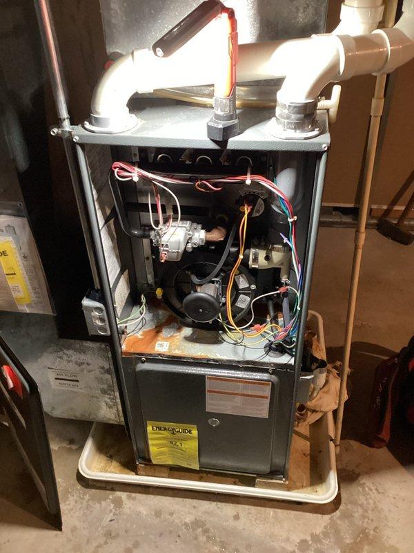Responded to no cooling complaint on residential HVAC system. Upon inspection, found significant rust and corrosion on condensate drain pan indicating active water damage and potential secondary drain pan failure. System was operational but unable to maintain desired temperature setpoint. Documented equipment condition with photos showing corroded components and advised homeowner of necessary repairs to prevent further deterioration and restore proper cooling function.
