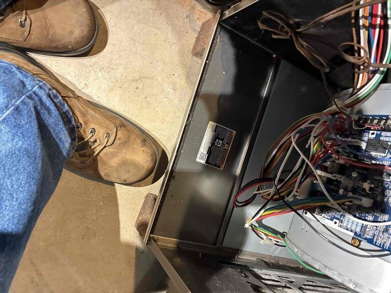 # HVAC Service Completion

Responded to ignition failure alert on aging HVAC system. Upon arrival, performed diagnostic evaluation using digital manometer to assess system pressures and identify root cause of no-cool condition. Inspected internal components including blower motor assembly, control boards, and electrical connections. 

Measured operating pressures at multiple test points to verify refrigerant charge and system performance. Examined wiring harness, control circuitry, and safety switches for proper operation. Evaluated blower motor housing and associated electrical controls for signs of wear or failure consistent with equipment age.

Documented system conditions with diagnostic readings and visual inspection findings. All components photographed for service records, showing pressure measurements and equipment configuration at time of service call.