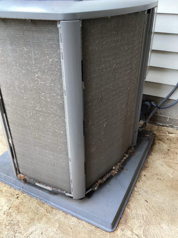 Completed annual tune-up and maintenance on Lennox outdoor condensing unit. Upon arrival, found significant debris accumulation on condenser coil fins including leaves, dirt, and organic matter concentrated along bottom edges and lower portions of unit. Cleaned condenser coils thoroughly, removed all debris from mesh filters and cabinet exterior, and restored proper airflow through heat exchanger. Performed standard maintenance protocol including refrigerant pressure checks, electrical connection inspection, amperage verification, and system operational testing. Unit returned to optimal operating condition with improved heat transfer efficiency following coil cleaning and comprehensive system evaluation.
