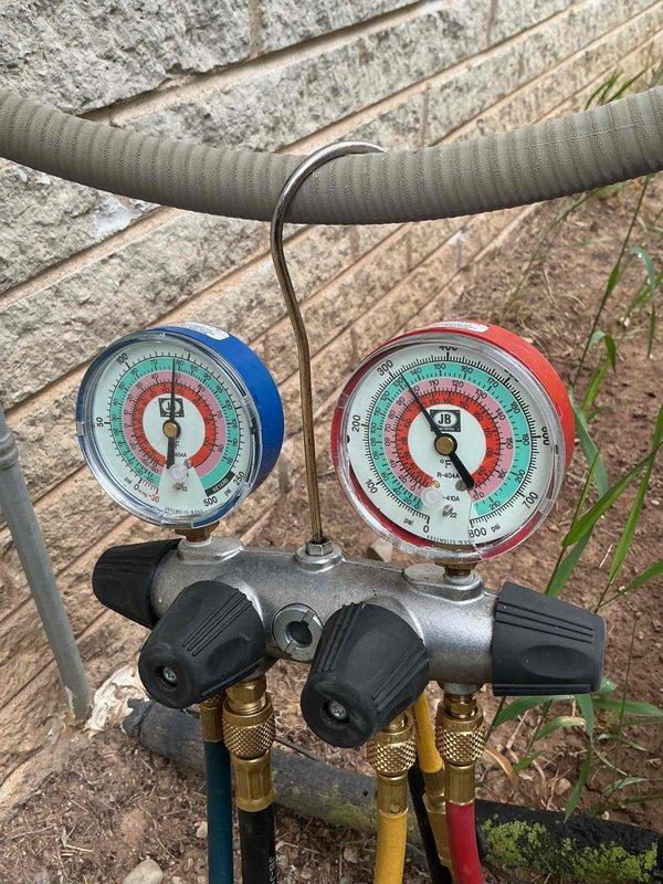 Completed prepaid annual cooling maintenance visit on residential air conditioning system. Performed comprehensive inspection of outdoor condenser unit, checked refrigerant pressures using manifold gauge set with readings within normal operating parameters, verified proper system operation, and documented equipment condition with photos. Unit operating efficiently with no issues identified.