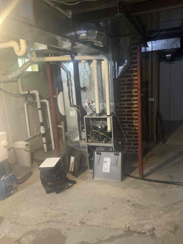 Completed residential HVAC system estimate for air conditioning replacement at property with existing furnace and ductwork infrastructure located in basement mechanical room. Assessed current equipment configuration including metal ductwork running through attic space adjacent to brick wall construction, evaluated furnace installation with supporting PVC drainage piping and existing rigid ductwork connections, and documented system layout for comprehensive replacement proposal.