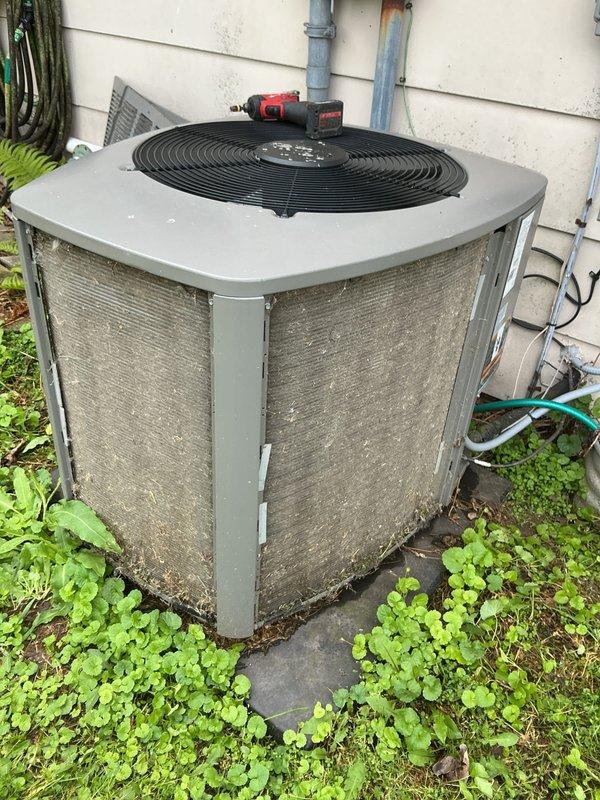 Completed routine membership cooling tune-up service on outdoor condensing unit. Upon arrival, found condenser coils heavily soiled with accumulated debris, dirt, and organic matter; cleaned and cleared exterior coils and surrounding area of leaves, vegetation, and buildup affecting airflow and system efficiency. Unit operational and tested satisfactory upon service completion.