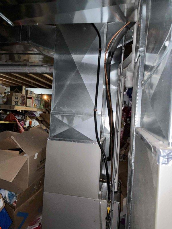 Completed comprehensive estimate for replacement of two non-functional residential air conditioning units and associated natural gas furnace systems located in basement. Both existing AC units determined to be beyond economical repair, requiring complete system replacement. Evaluated existing Carrier furnace installation, ductwork configuration, refrigerant line routing, and electrical connections to determine scope of replacement work. Documented current equipment specifications, venting systems including PVC intake and exhaust pipes, and existing infrastructure to provide accurate replacement recommendations for dual HVAC system installation.