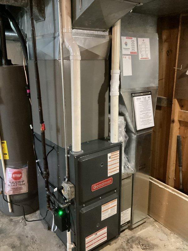 Completed installation of new Goodman HVAC system including air conditioning unit and evaporator coil in residential basement mechanical room. System was successfully installed, connected to existing ductwork, and all electrical and refrigerant lines were properly terminated. Equipment was tested and confirmed operational upon completion.