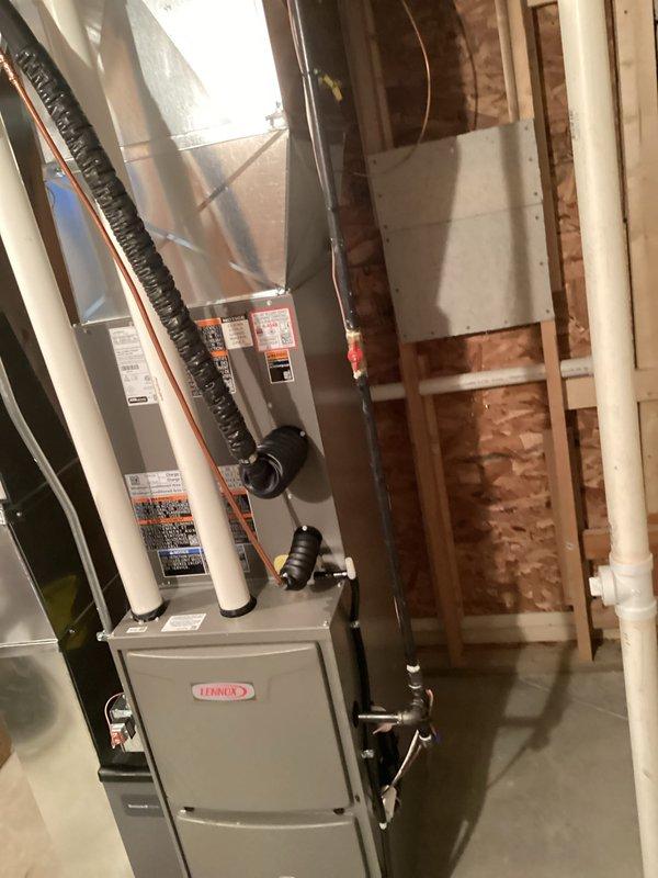 Completed full HVAC system installation including new Lennox furnace and air conditioning condenser units. Installed furnace in basement utility area with proper ductwork connections, refrigerant line routing, and PVC venting/drainage system. Set dual outdoor condenser units on concrete pad with electrical disconnect and meter connections, completed refrigerant line installation with proper insulation, and performed system startup and commissioning. All work completed with permits and electrical service coordinated as specified.
