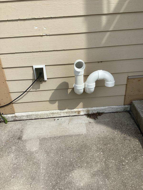 Completed full HVAC system installation including new furnace and air conditioning unit. Installed exterior condensate drainage system with PVC piping and proper venting through building exterior, along with electrical disconnect box and associated wiring. Configured condensate pump assembly with tubing and drainage components on interior concrete pad to ensure proper moisture removal from system operation.