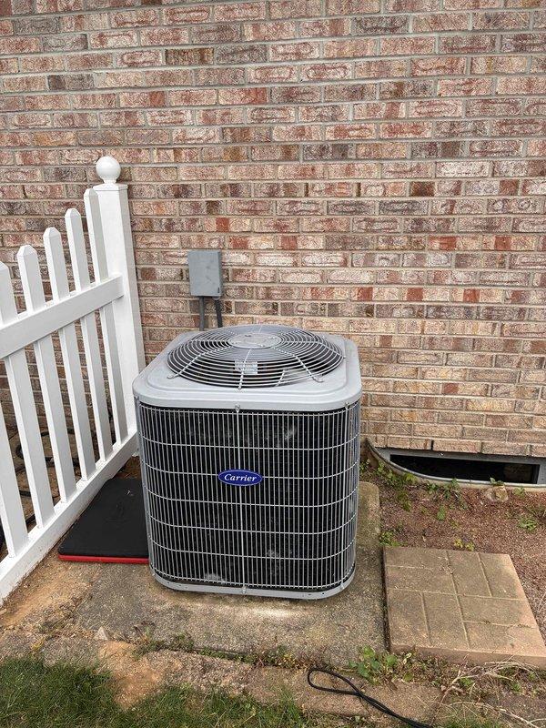 Responded to no cooling complaint on Carrier condensing unit. Upon arrival, performed diagnostic evaluation of outdoor unit positioned on concrete pad against exterior brick wall. Visually inspected condenser coil, fan assembly, electrical disconnect, and overall unit condition. Unit appeared properly installed with adequate clearance from fence line and maintained service access. Documented equipment information and current operating conditions through photographic records for service file. System evaluated and findings communicated to customer.