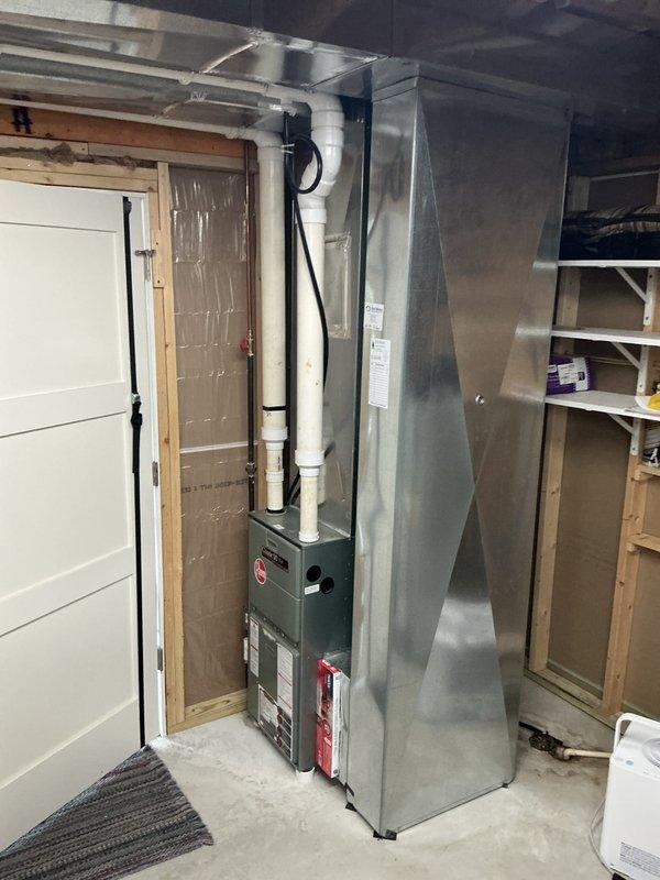 Responded to emergency HVAC replacement following fire damage caused by mouse nest in existing system. Completed full furnace and ductwork installation in basement utility space, including new gray furnace unit with proper venting through white PVC pipes, galvanized metal ductwork system, and electrical connections with black conduit routing.