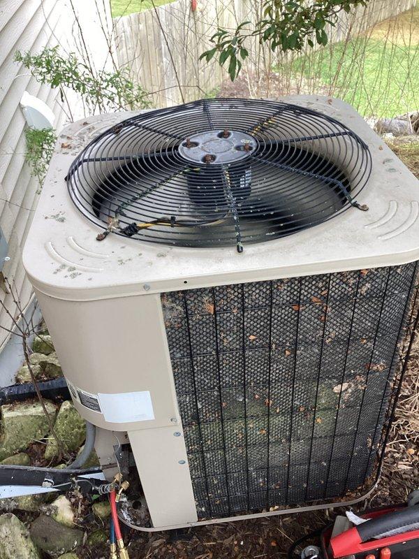 Responded to cooling deficiency complaint affecting family room and kitchen areas. Performed system evaluation of outdoor condensing unit and measured refrigerant pressures using manifold gauge set. Unit showed signs of age with vegetation encroachment and debris accumulation on cabinet and coil surfaces. Diagnostic testing completed to assess system performance and identify potential causes of reduced cooling capacity in affected zones.