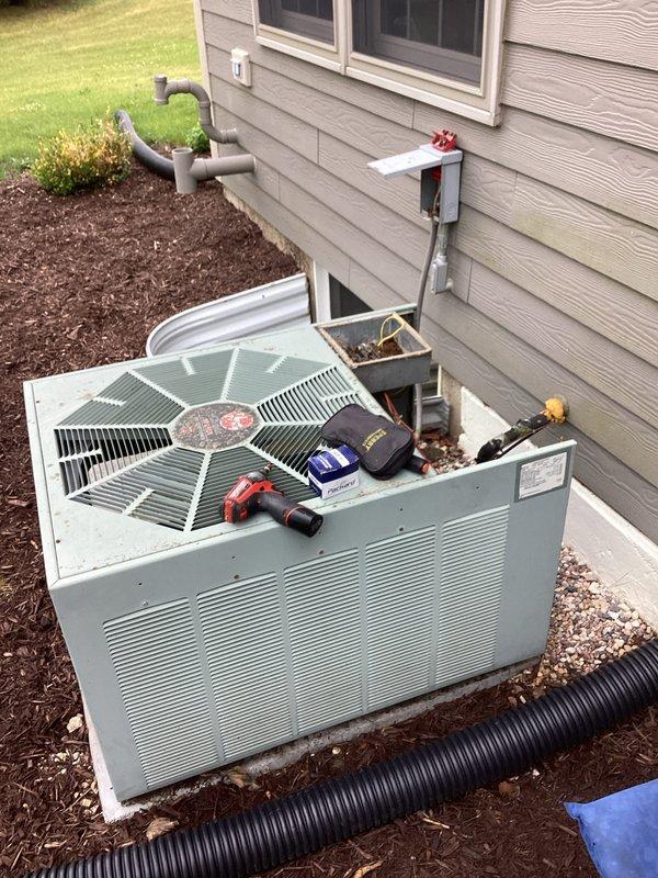 Responded to no cooling call on 22-year-old system experiencing freeze-up condition. Upon arrival, unit was off and evaporator coil was frozen. Inspected outdoor condenser unit and found electrical compartment heavily contaminated with leaves, dirt, and organic debris accumulation, indicating extended period without maintenance. Cleaned electrical components and removed all debris from contactor housing to restore proper operation and prevent potential electrical failures. Cycled system and verified proper operation after thaw period.