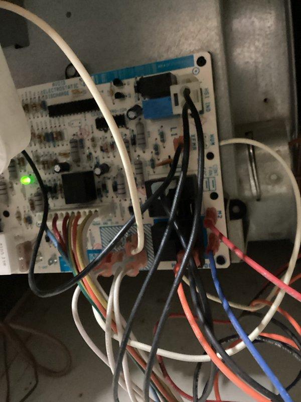Responded to no cooling complaint on aging residential air conditioning system. Upon inspection, found system low on refrigerant with active leak causing condensate overflow onto floor. Connected manifold gauges to assess system pressures and refrigerant charge levels. Diagnosed control board operation and verified electronic components functioning properly with LED indicators showing normal status. Due to age of unit (10+ years) and extent of refrigerant leak, recommended system evaluation for repair versus replacement options.