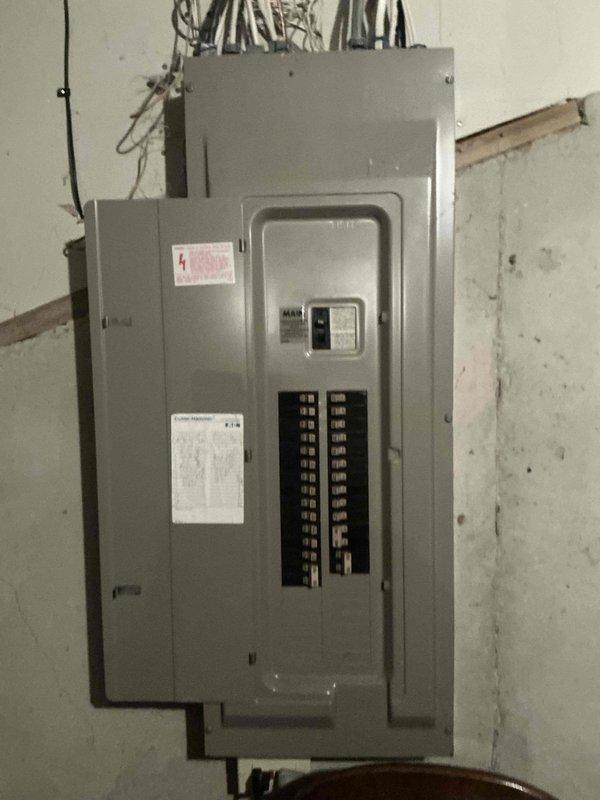 Completed comprehensive HVAC system replacement estimate for residential property with existing furnace installation in basement utility area. Documented current equipment configuration including electrical panel with main breaker and circuit distribution system, existing furnace unit with associated ductwork, and PVC condensate drainage system. Provided veteran's discount pricing for complete system replacement recommendation.