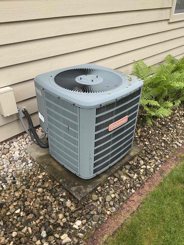 # HVAC Service Call - No Cooling Complaint

Responded to a no cooling complaint on a residential air conditioning system. Upon arrival, located the outdoor condensing unit installed on a gravel pad against the home's exterior. Performed initial visual inspection of the condenser unit, noting the system's age and overall condition.

Conducted electrical diagnostics using a digital multimeter to test voltage and electrical connections at the outdoor unit. Measured line voltage at the condenser, obtaining a reading of approximately 39 volts, which is significantly below the required 208-240 volt range for proper compressor and condenser fan motor operation. This low voltage condition would prevent the unit from starting and operating correctly.

Traced electrical wiring including the purple, brown, and red conductors running to the unit. Inspected the electrical disconnect, contactor, and capacitor connections. The substantially reduced voltage indicated either an upstream electrical supp