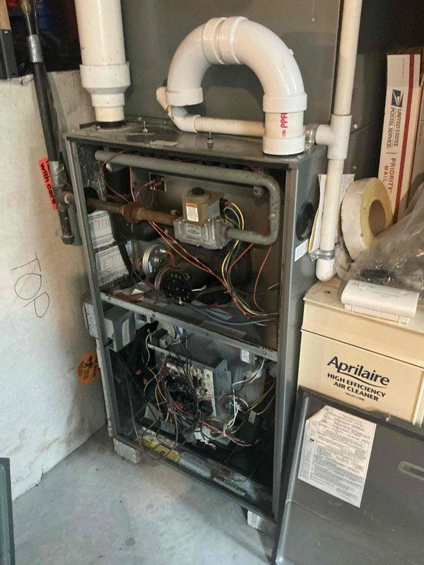 Responded to emergency service call for aging HVAC system that was temporarily restored to operation but requires replacement evaluation. Conducted comprehensive assessment of existing Arcoaire furnace installation, including inspection of internal components, blower motor assembly, control boards, electrical wiring harnesses, and burner assemblies. Evaluated PVC condensate drain line configuration and venting system integrity. Documented current system condition through detailed photography showing cabinet construction, mechanical components, and Aprilaire air cleaner integration. Provided estimate for complete furnace and air conditioning system replacement based on equipment age and observed wear patterns.