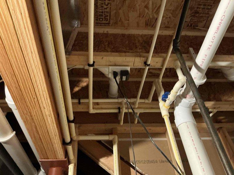 Conducted estimate for water heater replacement due to active leak in existing unit. Assessed plumbing infrastructure including PVC drainage lines, supply piping, and ceiling-mounted utility systems in unfinished space to determine replacement requirements and accessibility for installation.