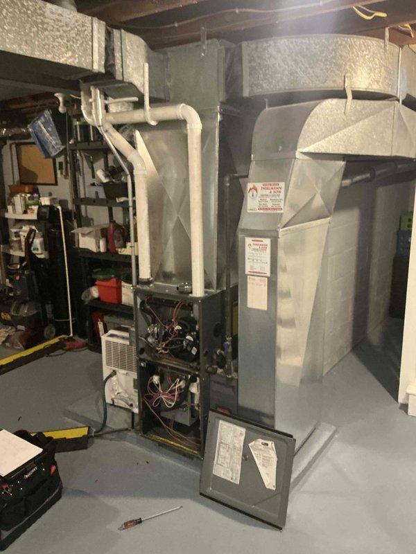 Responded to no cooling emergency call and performed comprehensive system assessment. Documented existing HVAC equipment configuration including furnace unit, ductwork, and condensing unit setup in mechanical room. Evaluated current system condition, noting operational components, electrical connections, and PVC condensate drainage. Provided detailed replacement estimate for complete HVAC system upgrade to restore cooling capability and improve overall system efficiency.