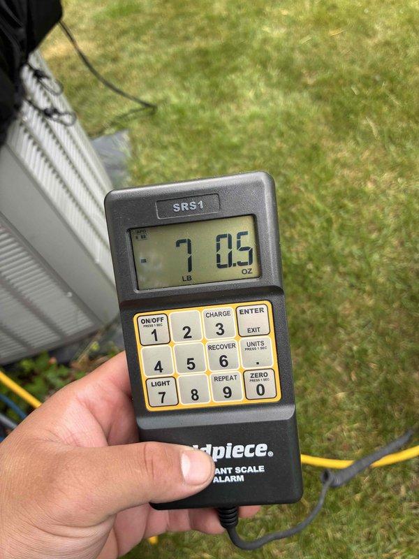 Responded to no cooling complaint on residential system installed in 2021 and covered under 10-year parts warranty. Upon arrival, confirmed unit was running but not producing cool air. Performed diagnostic evaluation and determined system was low on refrigerant charge. Connected manifold gauges and verified insufficient charge levels. Evacuated remaining refrigerant, conducted leak search, and recharged system to manufacturer specifications using calibrated digital scale to ensure proper refrigerant weight. System tested successfully with proper cooling operation restored upon completion.
