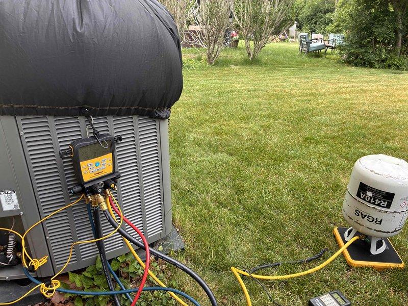 Responded to no cooling complaint on residential system installed in 2021 and covered under 10-year parts warranty. Upon arrival, confirmed unit was running but not producing cool air. Performed diagnostic evaluation and determined system was low on refrigerant charge. Connected manifold gauges and verified insufficient charge levels. Evacuated remaining refrigerant, conducted leak search, and recharged system to manufacturer specifications using calibrated digital scale to ensure proper refrigerant weight. System tested successfully with proper cooling operation restored upon completion.