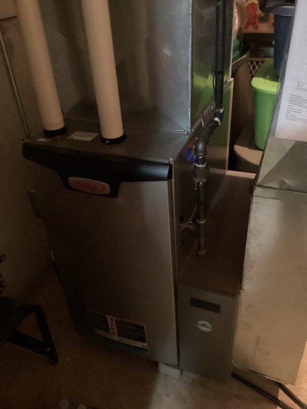 # HVAC Service Report - No Cool Condition

Responded to a no cooling call on a residential HVAC system less than 10 years old. Upon arrival, conducted a comprehensive system diagnostic to identify the cause of cooling failure. Inspected the furnace unit and associated ductwork components located in the basement mechanical room.

Performed visual inspection of the air handler, ductwork, and refrigerant lines. Examined copper refrigerant piping for proper installation and potential leak points. Checked condensate drain system including black plastic drain valves and fittings for proper operation and blockages. Assessed the condition of metal ductwork, noting weathering and surface discoloration consistent with normal system operation in a basement environment.

Evaluated furnace control panel operation and verified proper electrical connections. Inspected PVC vent pipes for proper exhaust ventilation. Tested system controls and thermostat communication to identify cooling mode failure po