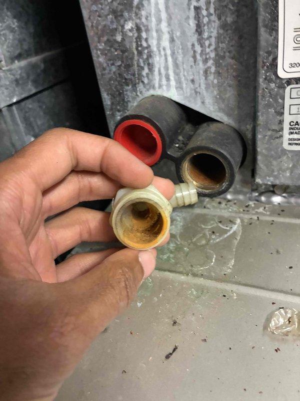 Responded to no cooling call on commercial AC unit. Upon inspection, found system running but not producing cool air. Diagnosed issue as failed compressor due to internal mechanical failure, evidenced by corroded and mineral-stained service port fittings. Thermostat showing permanent hold at 75°F with cooling mode active but unable to satisfy setpoint. Advised customer of compressor replacement requirement to restore cooling function.