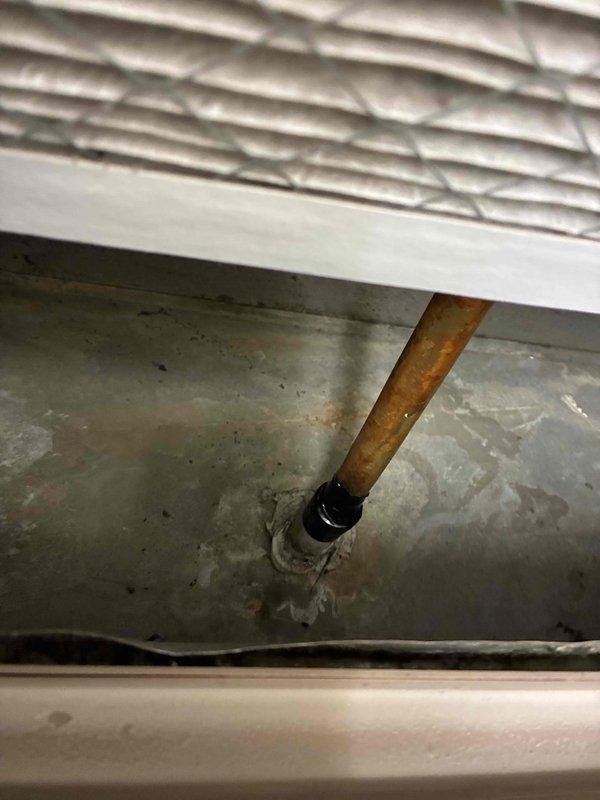 Responded to service call for MagicPak unit with reported refrigerant leak. Upon arrival, coordinated with homeowner regarding pets prior to beginning work. Inspection revealed significant corrosion and oxidation on copper refrigerant line with visible leak at connection point. Due to severity of leak and system integrity concerns, unit was shut down to prevent further refrigerant loss and potential compressor damage. Documented condition with photos showing corroded copper piping with rust patina and deteriorated coupling seal. Also noted heavily soiled air filter requiring replacement during future service. Unit remains offline pending parts procurement and repair under existing 5-year parts and 1-year labor warranty coverage.