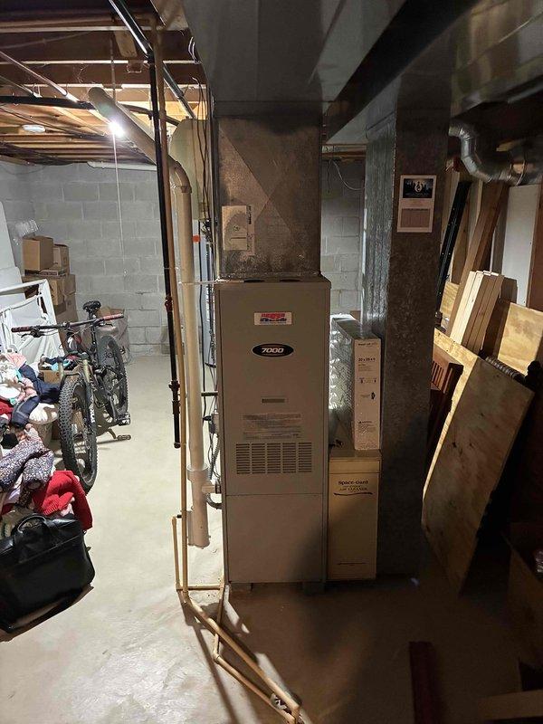 Completed estimate for full HVAC system replacement at residential property. Evaluated existing Zieco furnace located in basement utility room and outdoor AC condenser unit with grid-pattern fan grille; outdoor unit showing signs of neglect with vegetation growth around base and confirmed non-operational status. Provided replacement recommendations for both heating and cooling equipment to restore complete climate control functionality.