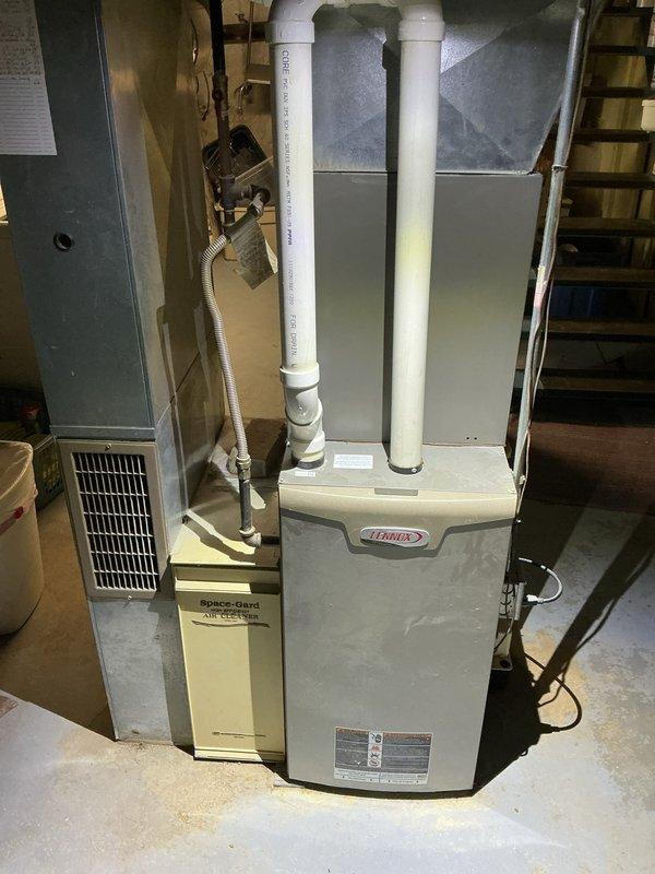 Completed comprehensive tune-up on Lennox furnace and air conditioning system. Performed full system inspection including burner assembly, heat exchanger, blower motor, and electrical connections on heating unit. Inspected Space-Gard air filtration system for proper operation. Checked all ductwork connections, PVC intake and exhaust venting, and verified proper drainage. Tested thermostat operation, measured temperature differentials, and confirmed all safety controls functioning correctly. System operating within manufacturer specifications with no deficiencies noted.