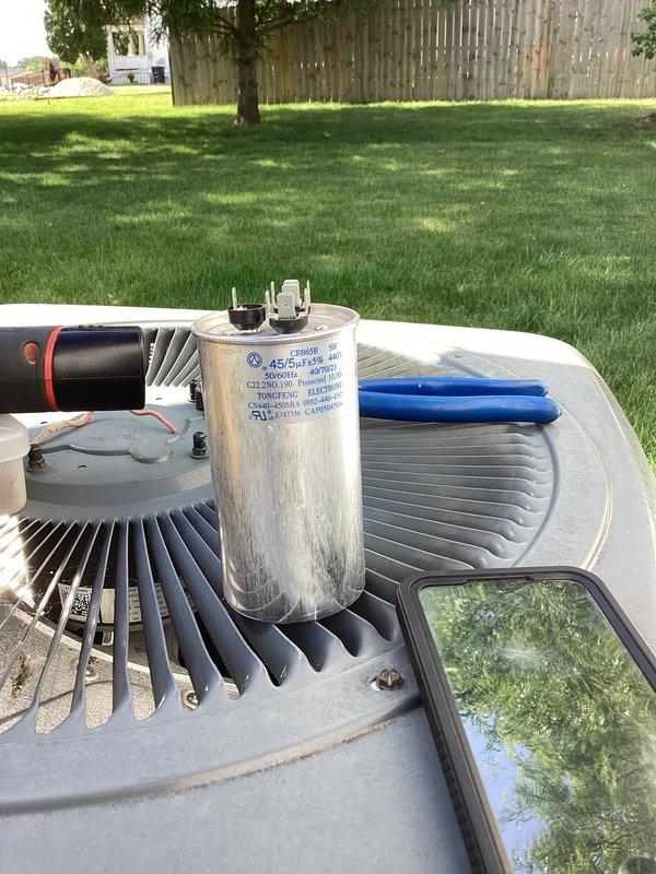 # HVAC Service Report - No Cool Condition

Responded to service call for air conditioning system running but not cooling residence, with furnace emitting periodic beeping sounds. Upon arrival, performed diagnostic evaluation of 10+ year old split system.

Inspected outdoor condensing unit and found failed dual run capacitor. Capacitor tested outside acceptable microfarad range, preventing compressor from operating properly while allowing condenser fan motor to run. This condition resulted in system appearing to operate normally while producing no cooling capacity.

Examined indoor air handler and identified source of beeping as low-voltage fault alarm from control board, triggered by communication error between outdoor and indoor units due to capacitor failure preventing compressor operation.

Replaced failed dual run capacitor with manufacturer-specified replacement unit. Verified proper electrical connections and secure mounting. Tested system operation and confirmed compressor start
