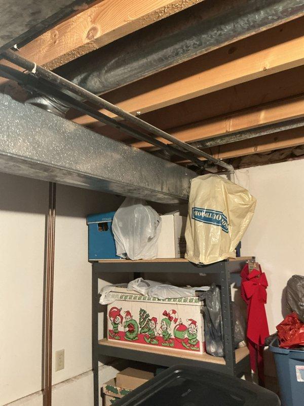 Conducted on-site evaluation for complete HVAC system replacement in basement mechanical room. Assessed existing furnace and air conditioning equipment, documented current installation including copper refrigerant line routing, electrical connections, and ductwork configuration. Photographed equipment specifications, clearances, and surrounding utility space to prepare comprehensive replacement estimate for new heating and cooling system.