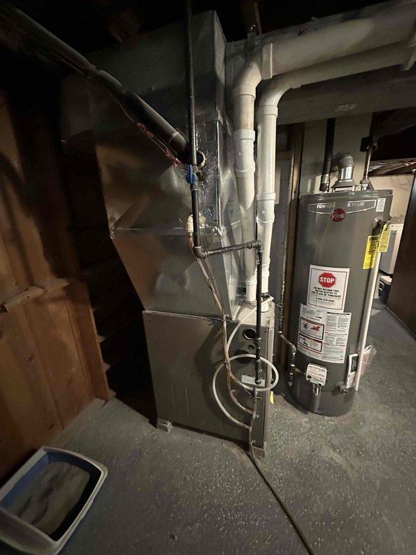Conducted comprehensive estimate for complete HVAC system replacement including air conditioning unit and furnace located in basement mechanical room. Assessed existing equipment configuration, electrical service panel capacity, venting system, and spatial requirements for new installation while documenting current system layout with detailed photographs for replacement planning purposes.
