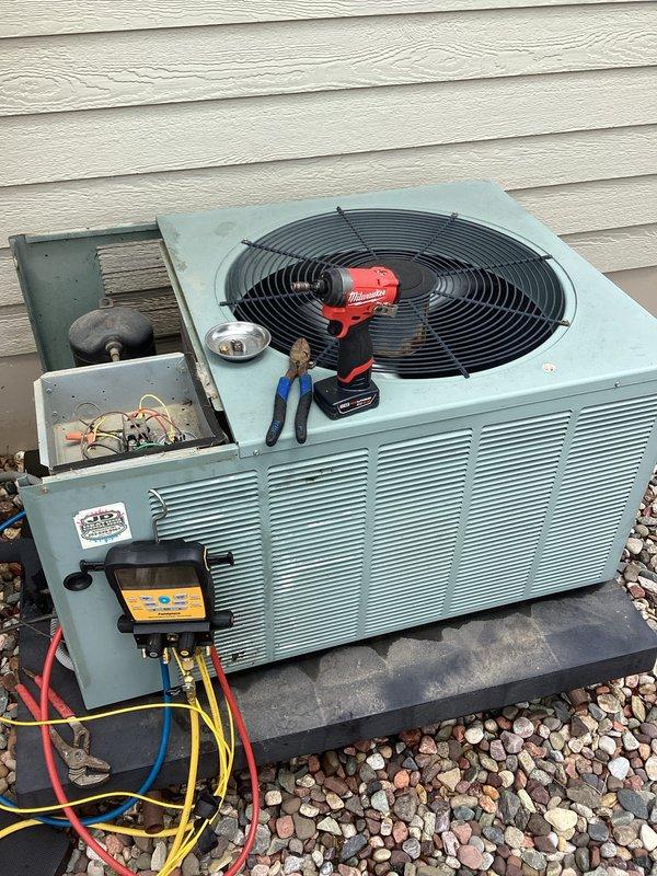 Responded to service call for AC unit short cycling - turning on briefly then shutting off after a few minutes before restarting. Upon arrival, performed diagnostic evaluation of outdoor condensing unit. Inspected electrical components in junction box and found contactor showing signs of age and corrosion. Connected manifold gauge set to check refrigerant pressures and system operation. Tested capacitor function and verified all electrical connections. Identified worn contactor as primary cause of intermittent operation and short cycling behavior. System components showed significant weathering consistent with extended outdoor exposure but capacitor tested within normal specifications.