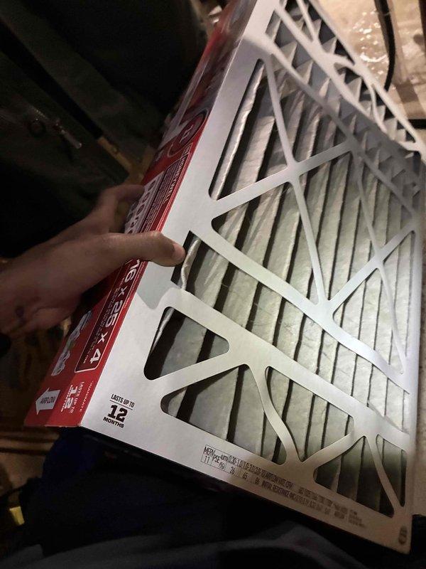 Completed air conditioning tune-up service at residential property. Inspected outdoor condensing unit and found heavily soiled air filter with significant dust and debris accumulation restricting airflow. Removed and replaced dirty filter with new pleated HVAC filter to restore proper system ventilation and efficiency.