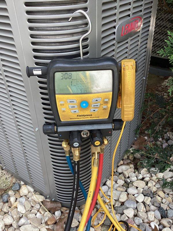 Completed installation of new Lennox air conditioning system including outdoor condensing unit and evaporator coil. Unit was properly positioned on vibration-dampening pads over gravel base, refrigerant lines were connected and insulated, and system was charged to manufacturer specifications. System was tested using digital manifold gauges to verify proper refrigerant pressures, superheat, and subcooling values, confirming optimal performance and successful startup of the new HVAC equipment.