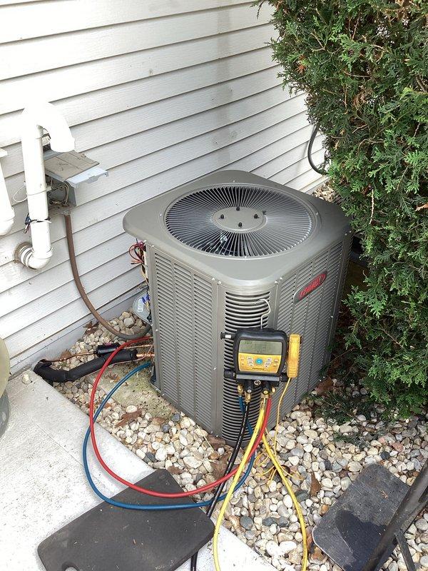 Completed installation of new Lennox air conditioning system including outdoor condensing unit and evaporator coil. Unit was properly positioned on vibration-dampening pads over gravel base, refrigerant lines were connected and insulated, and system was charged to manufacturer specifications. System was tested using digital manifold gauges to verify proper refrigerant pressures, superheat, and subcooling values, confirming optimal performance and successful startup of the new HVAC equipment.