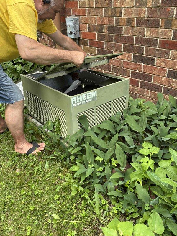 Conducted on-site assessment for complete HVAC system replacement, evaluating existing Rheem high-efficiency air conditioning unit and natural gas furnace located in basement. Inspected outdoor condenser unit components, electrical disconnect panel with dedicated AC circuit breaker, and associated service equipment to determine replacement specifications and requirements for new system installation.