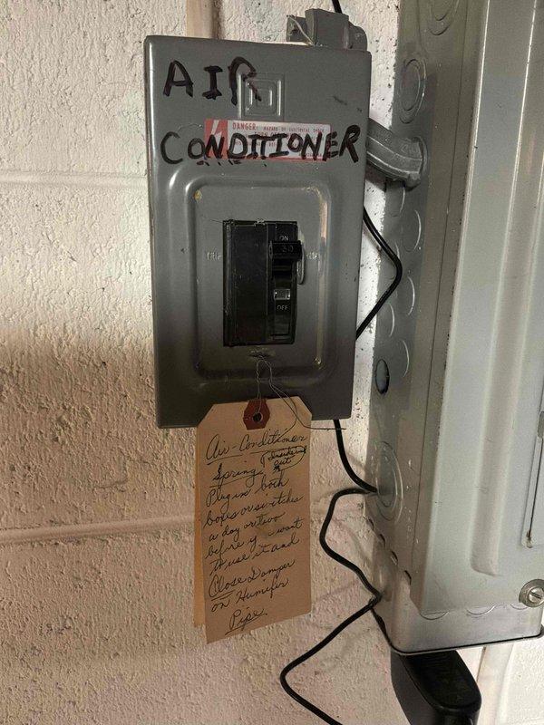 Conducted on-site assessment for complete HVAC system replacement, evaluating existing Rheem high-efficiency air conditioning unit and natural gas furnace located in basement. Inspected outdoor condenser unit components, electrical disconnect panel with dedicated AC circuit breaker, and associated service equipment to determine replacement specifications and requirements for new system installation.