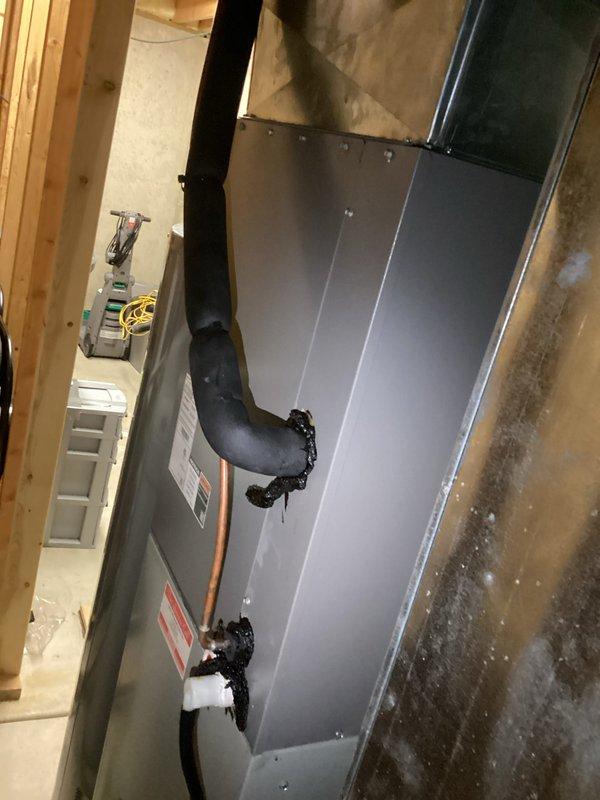 Responded to no cooling call on Trane XE 90 system. Upon arrival, found ice buildup on evaporator coil and outdoor fan motor not operating. Diagnosed failed condenser fan motor preventing proper heat rejection, causing system to ice up and shut down on safety. Replaced defective fan motor, verified proper rotation and amperage draw, allowed coil to thaw completely, and restored system to normal cooling operation with all safeties functioning correctly.
