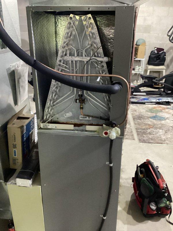 Responded to no heat call and found air handler evaporator coil frozen due to restricted airflow. System was shut down to allow coil to thaw completely. Inspected unit and verified refrigerant lines, drain pan assembly, and internal components. Advised customer on proper filter maintenance to prevent future freeze-ups and restored system to normal operation once coil defrosted.