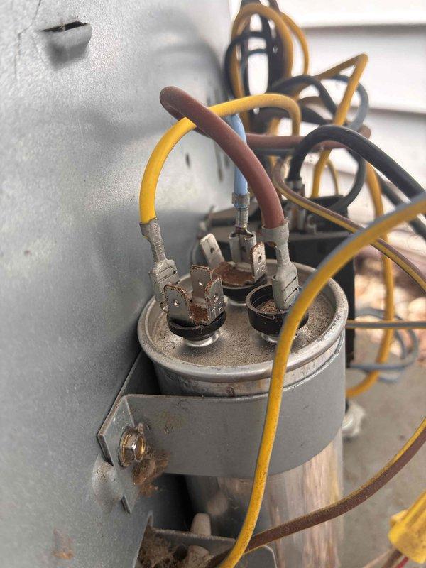 Responded to no cooling call on aging HVAC system. Upon inspection, found failed dual-run capacitor with visible deterioration and corrosion on terminals and housing. Replaced defective capacitor with new TITAN PRO TRCFD355 rated at 35/5µF 440/370V AC. Verified proper electrical connections, tested system operation, and confirmed unit returned to normal cooling function.