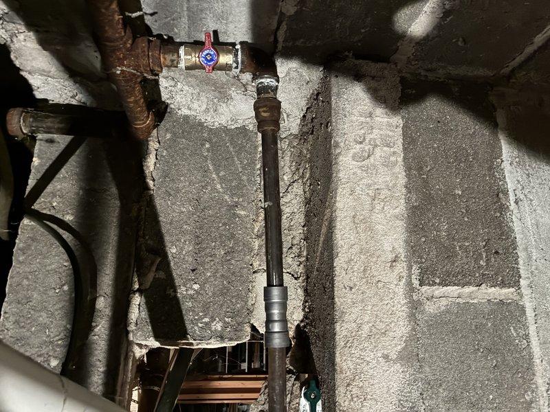 Responded to gas company-marked leak on valve in basement plumbing system. Upon inspection, identified small gas leak at valve connection point on aging copper gas line with visible corrosion. Repaired leak at valve assembly, performed pressure test to verify system integrity, and confirmed no additional leaks present in accessible piping.