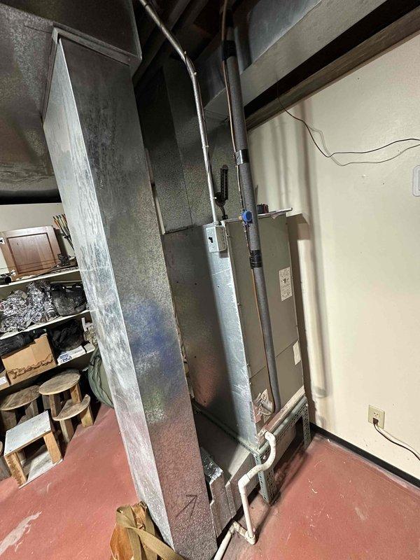 Provided estimate for replacement of 26-year-old air handler unit located in basement that has stopped working. Assessed existing HVAC system, documented current equipment condition, and photographed installation area including ductwork connections and electrical components to prepare comprehensive replacement proposal.