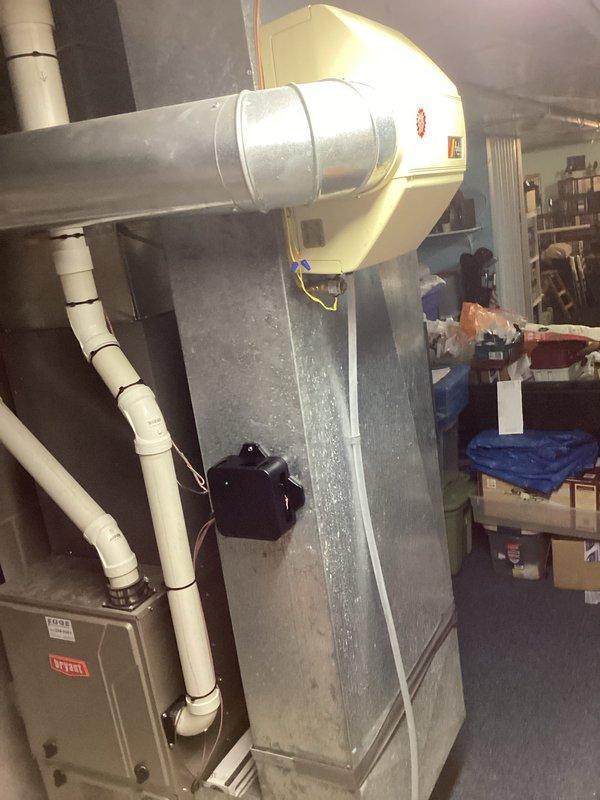 Completed full HVAC system installation including outdoor condensing unit and indoor evaporator coil. Installed new beige cylindrical condenser unit on concrete pad against building exterior with proper clearances for airflow and service access. Mounted evaporator coil assembly with blower housing in mechanical room, integrated with existing ductwork system. Established refrigerant line connections between outdoor and indoor components. Installed condensate drain lines using white PVC piping with proper pitch and termination. Coordinated with licensed electrician for dedicated circuit and disconnect installation. All work performed under obtained permits in compliance with local building codes and manufacturer specifications. System tested for proper operation, refrigerant charge verified, and airflow confirmed throughout distribution system.