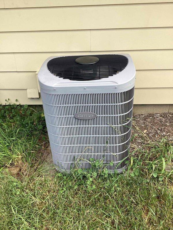 Responded to service call for intermittent cooling issue on Carrier outdoor condensing unit. Upon arrival, performed visual inspection of equipment and noted vegetation growth around base of unit and debris accumulation near condenser coils. Unit appeared to be operational but likely experiencing reduced airflow efficiency due to restricted airflow around heat exchanger fins, which could cause intermittent cooling performance and reduced system capacity during peak demand periods.