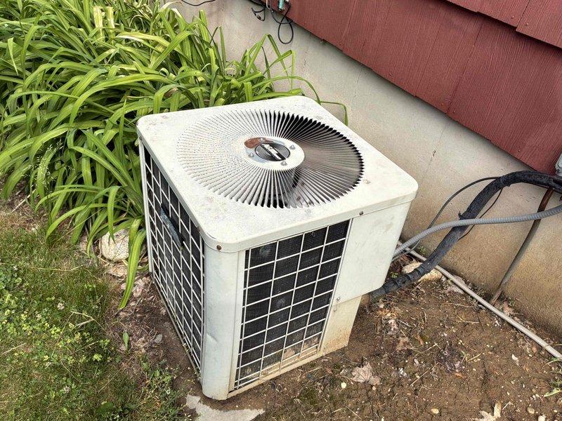Completed on-site evaluation of existing HVAC system for replacement estimate. Assessed aging natural gas furnace located in basement mechanical room and exterior air conditioning condenser unit. Furnace had experienced operational issues during previous winter season. Documented current equipment conditions through photographic inspection, noting weathered outdoor condenser unit with visible aging and indoor furnace installation alongside water treatment equipment. Provided comprehensive replacement options including furnace-only replacement and combined furnace and AC system replacement to address customer's heating and cooling needs.