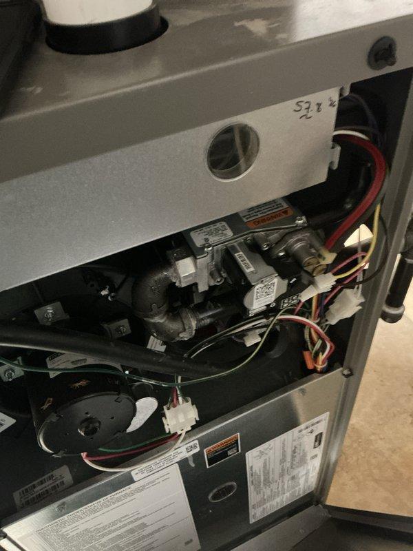 Responded to service call for reported gas odor in furnace exhaust. Performed comprehensive safety inspection of Lennox Elite gas furnace system, including visual examination of heat exchanger, burner assembly, gas valve connections, and venting components. Inspected all gas piping connections, flue pipe seals, and combustion chamber for potential leaks or compromised components. Verified proper operation of blower motor assembly and examined electrical connections to gas valve. All components found to be functioning within normal parameters with no active gas leaks detected at time of inspection.
