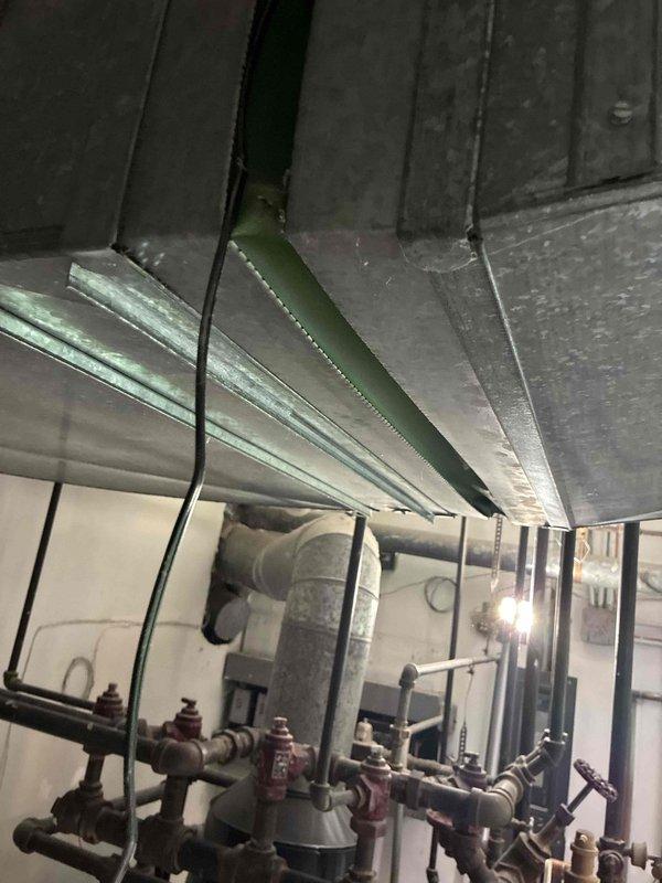 Completed installation of Unico air handler system in utility room over a three-day period. System includes properly configured ductwork, supply and return air components with wall-mounted return grille, and all necessary piping and valve assemblies for optimal operation.