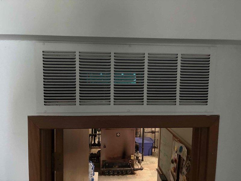 Completed installation of Unico air handler system in utility room over a three-day period. System includes properly configured ductwork, supply and return air components with wall-mounted return grille, and all necessary piping and valve assemblies for optimal operation.