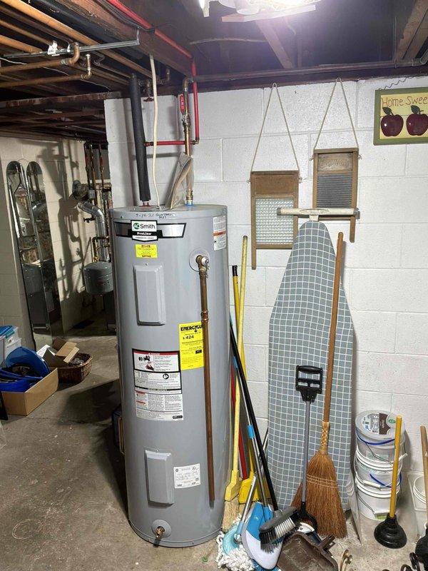 Provided estimate for replacement of existing 50-gallon electric water heater with upgraded 80-gallon electric water heater at rental property. Assessed current A.O. Smith unit installation in basement utility area, evaluated existing plumbing connections including copper supply lines and electrical configuration, and documented conditions for scope of work proposal.